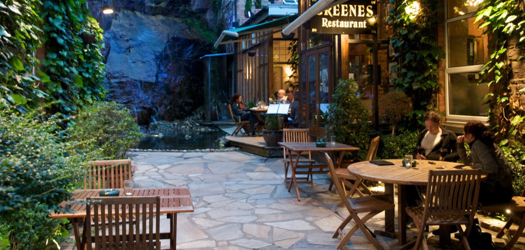 guests-enjoying-glass-of-wine-outside-Greenes-Restaurant-in-Cork-1080x514.jpg